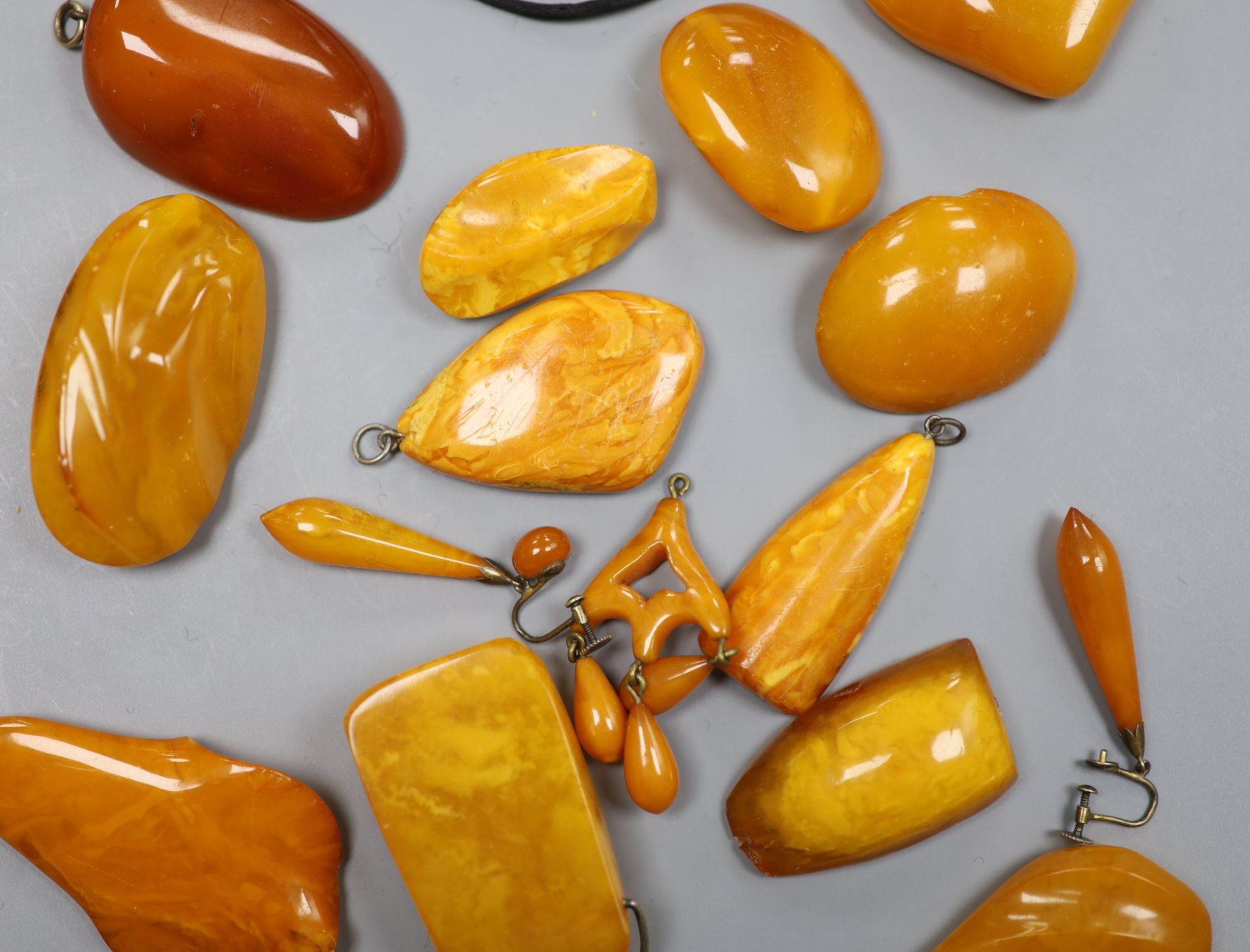 A group of assorted amber jewellery including, earrings, brooches and pendants, gross weight 136 grams.